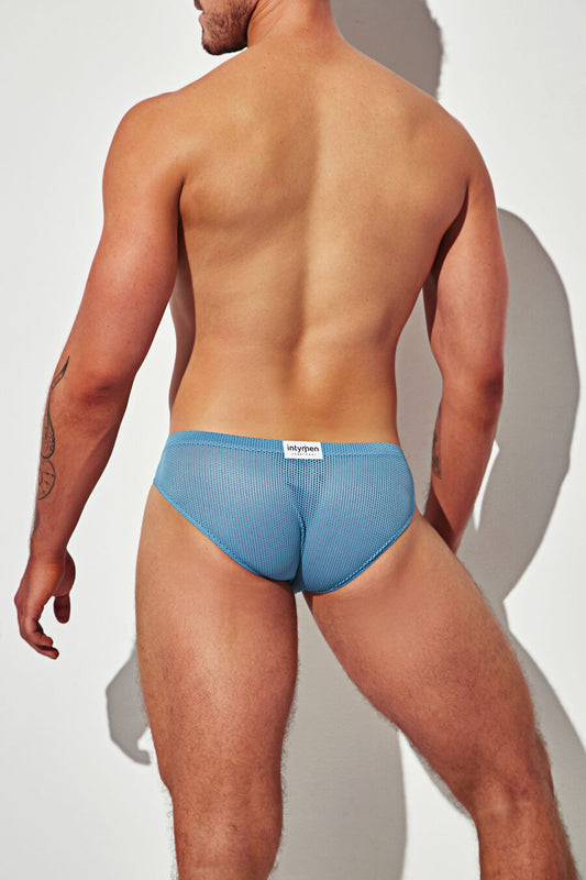 Back view of a light blue ribbed thong featuring a contoured fit and subtle Intymen label — minimal coverage with a sleek, athletic cut.