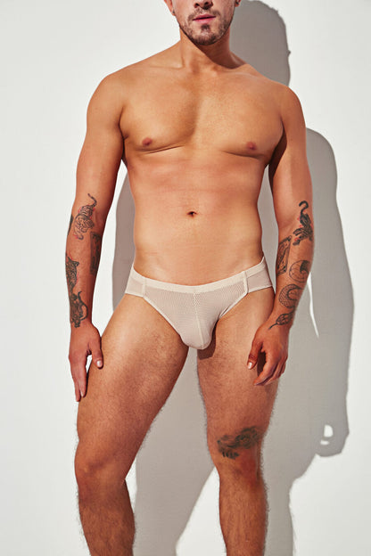 Beige mesh brief with a supportive pouch and breathable, sheer design.
