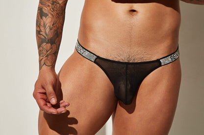 Black sheer thong with silver rhinestone “SEXY” waistband.