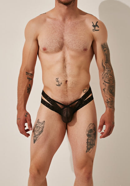 Man in black lace underwear, front view.
